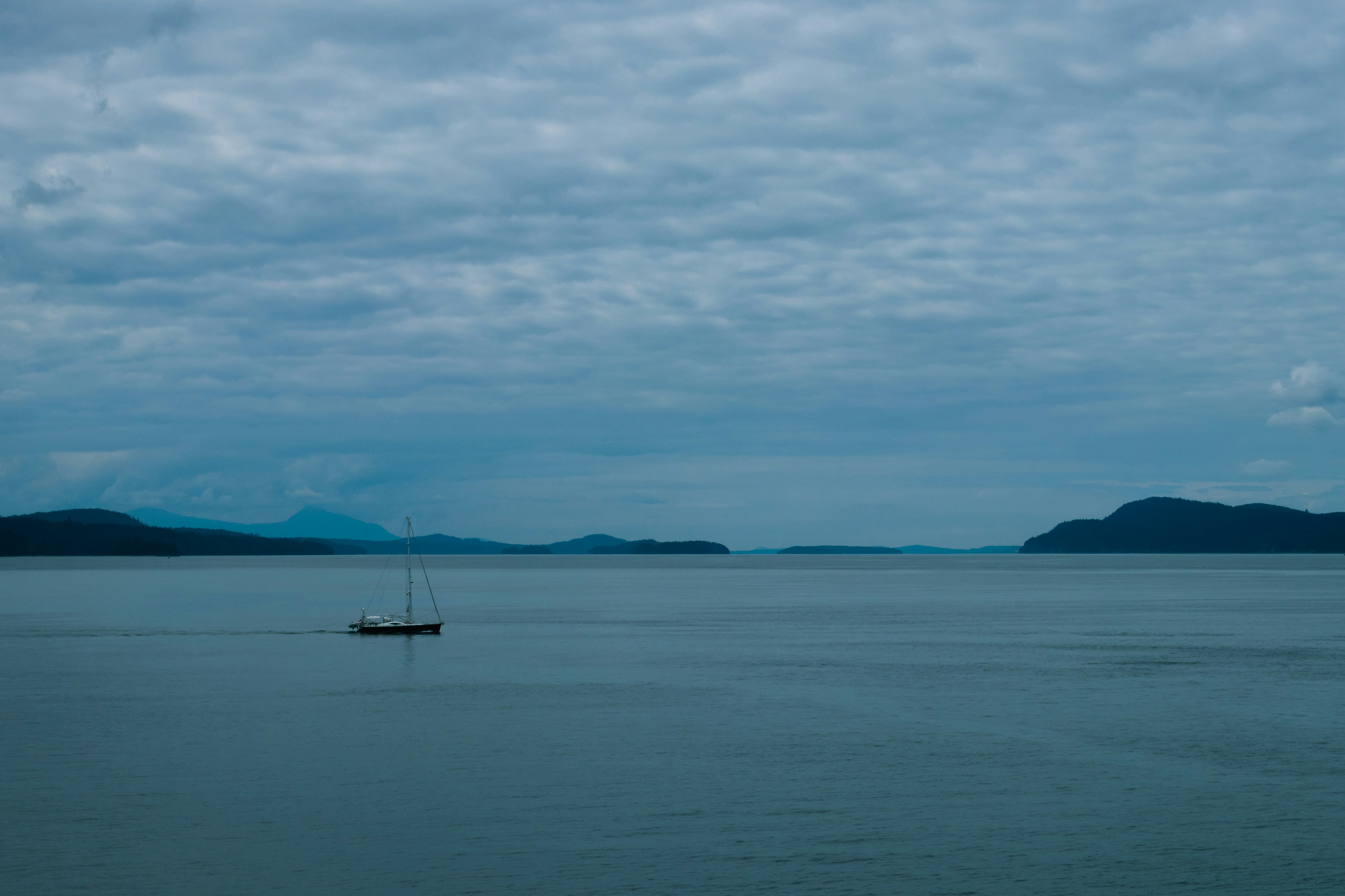 boat on sea under cloudy sky during daytime